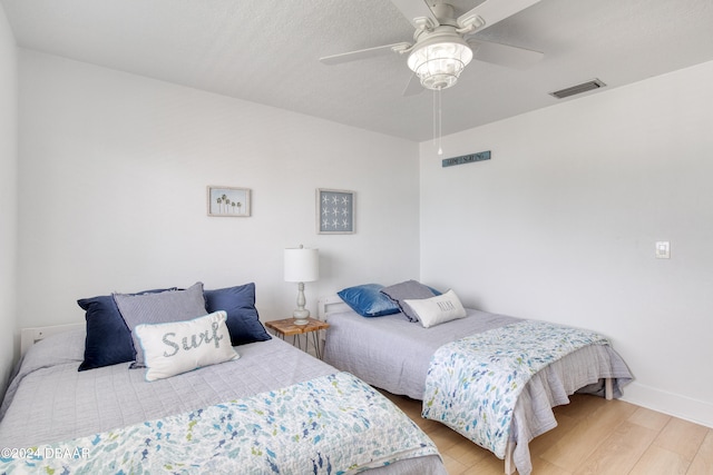 bedroom featuring ceiling fan and light hardwood / wood-style flooring