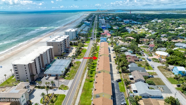 birds eye view of property with a view of the beach and a water view