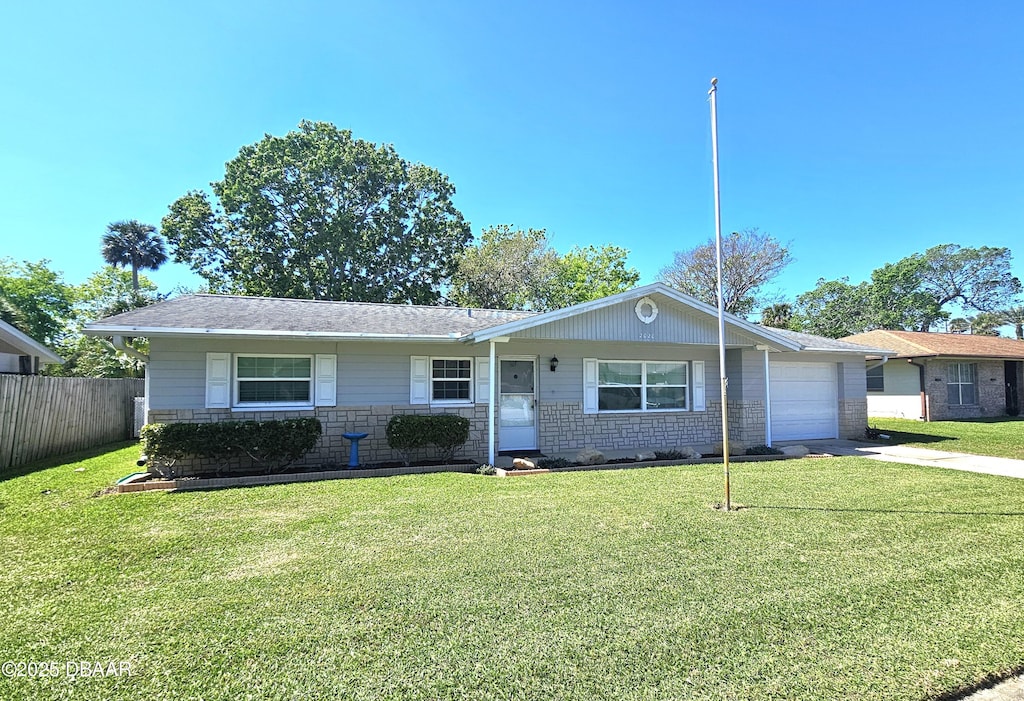 ranch-style home featuring a garage, concrete driveway, a front lawn, and fence