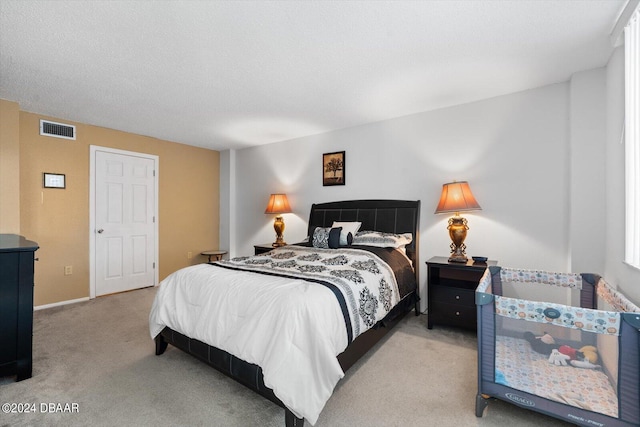 carpeted bedroom featuring a textured ceiling