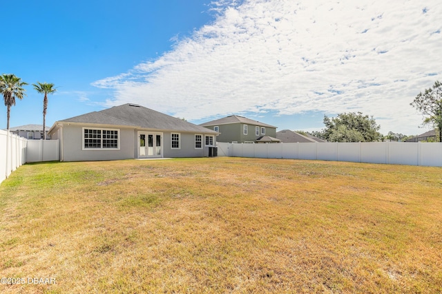 117 Boysenberry Ln, Daytona Beach, FL 32124 - back of property with a fenced backyard, stucco siding, and a yard
