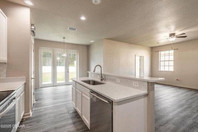 117 Boysenberry Ln, Daytona Beach, FL 32124 - kitchen featuring a textured ceiling, appliances with stainless steel finishes, dark wood-style floors, and a sink