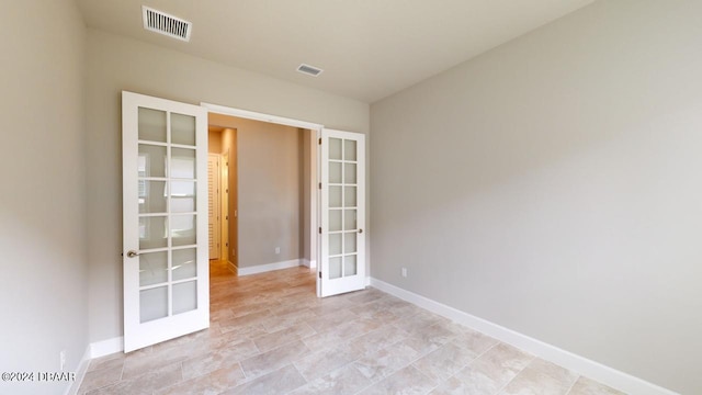 empty room featuring french doors