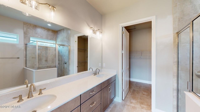 bathroom featuring walk in shower, vanity, and tile patterned flooring