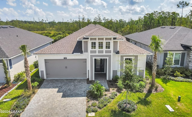 view of front of home featuring a front lawn and a garage