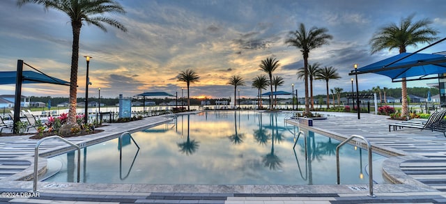 view of pool at dusk