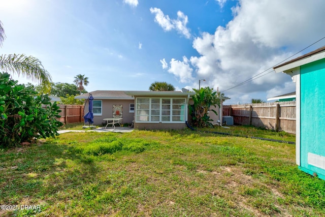 back of property featuring a patio area, a fenced backyard, and a lawn