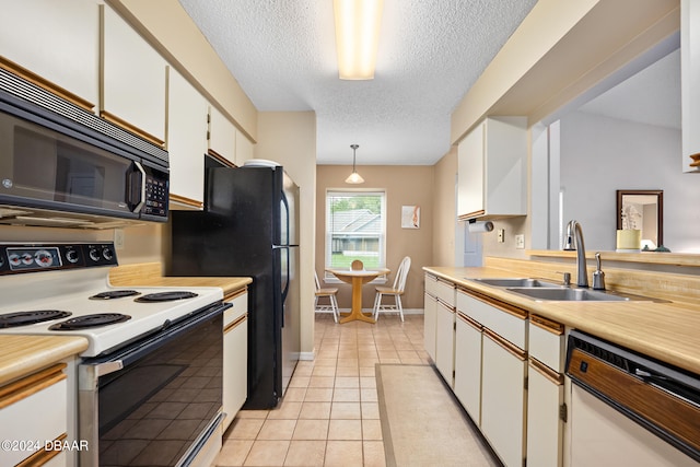 kitchen featuring white cabinetry, sink, a textured ceiling, hanging light fixtures, and white appliances