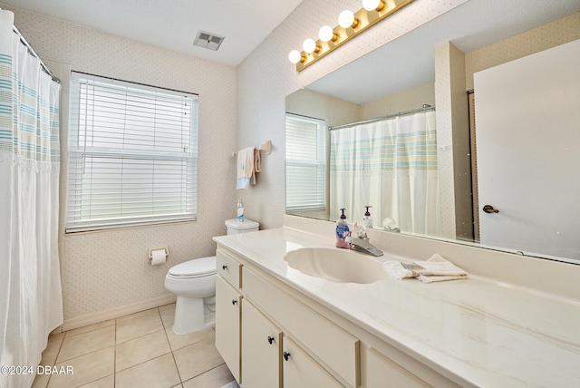 bathroom featuring tile patterned flooring, vanity, and toilet