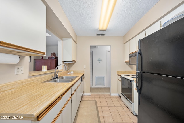 kitchen featuring black appliances, a textured ceiling, light tile patterned floors, sink, and white cabinets