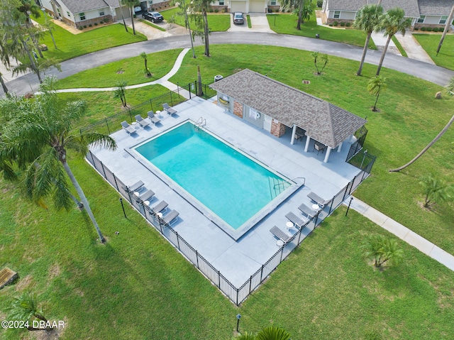 view of pool with a lawn and a patio