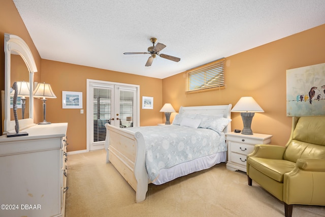 bedroom with french doors, access to exterior, a textured ceiling, light carpet, and ceiling fan