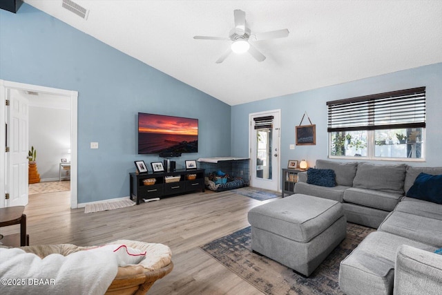 living room with lofted ceiling, ceiling fan, and wood-type flooring