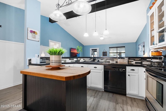 kitchen featuring dishwasher, decorative light fixtures, a kitchen island, and tasteful backsplash