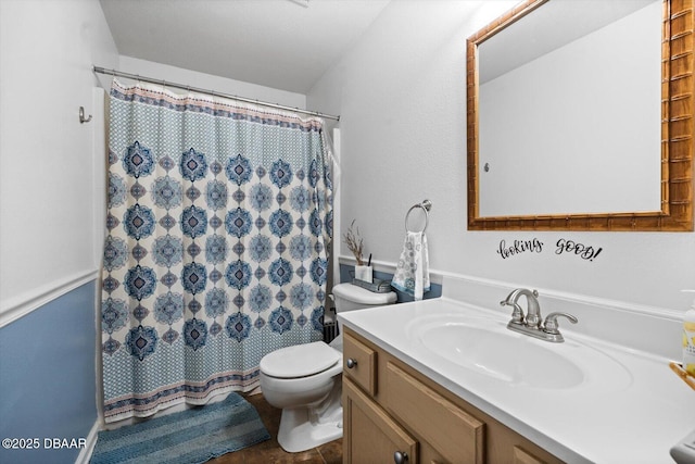 bathroom with a shower with curtain, vanity, and toilet