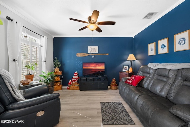 living room with ceiling fan, light hardwood / wood-style floors, and ornamental molding