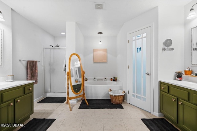 bathroom featuring tile patterned flooring, vanity, and shower with separate bathtub