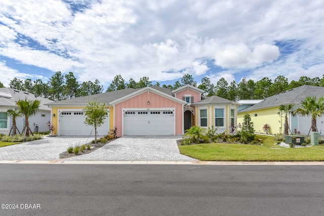 ranch-style home with a front lawn, central air condition unit, and a garage