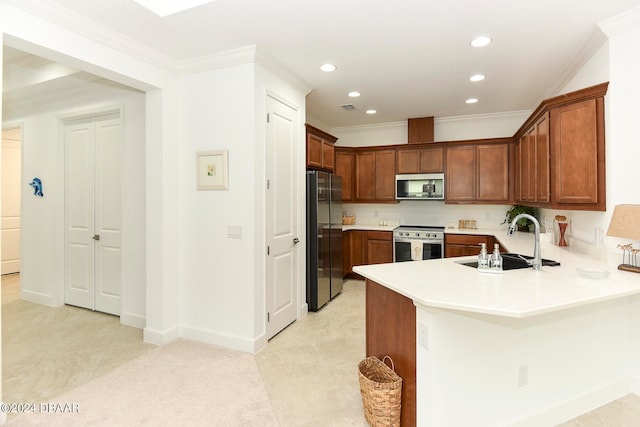 kitchen featuring ornamental molding, kitchen peninsula, appliances with stainless steel finishes, and sink