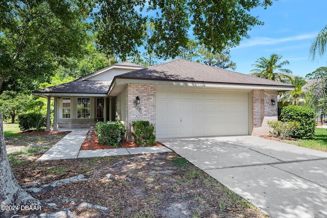 212 Glenbriar Cir, Daytona Beach, FL 32114 - ranch-style home with brick siding, a garage, driveway, and roof with shingles