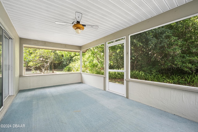 unfurnished sunroom with ceiling fan