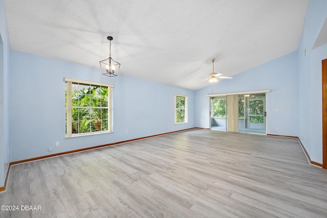 212 Glenbriar Cir, Daytona Beach, FL 32114 - empty room featuring wood finished floors, baseboards, ceiling fan, lofted ceiling, and a textured ceiling