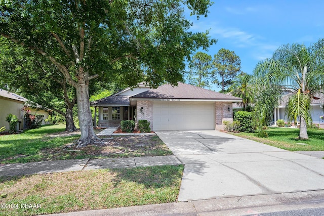 212 Glenbriar Cir, Daytona Beach, FL 32114 - ranch-style house with an attached garage, brick siding, driveway, and a front yard