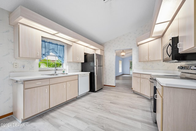 212 Glenbriar Cir, Daytona Beach, FL 32114 - kitchen featuring appliances with stainless steel finishes, a sink, wallpapered walls, light brown cabinets, and vaulted ceiling