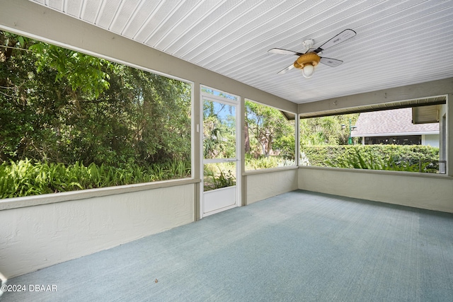 unfurnished sunroom with ceiling fan