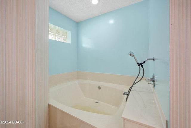 212 Glenbriar Cir, Daytona Beach, FL 32114 - bathroom with a textured ceiling and a garden tub