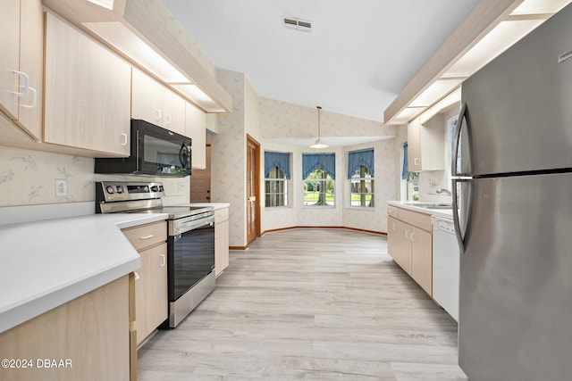 kitchen featuring lofted ceiling, decorative light fixtures, light hardwood / wood-style floors, and stainless steel appliances