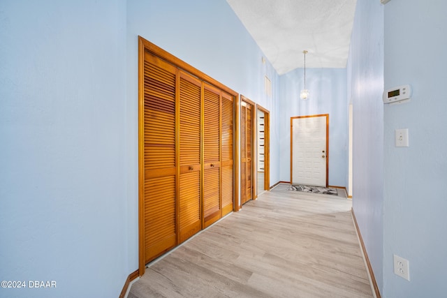 corridor with light hardwood / wood-style flooring