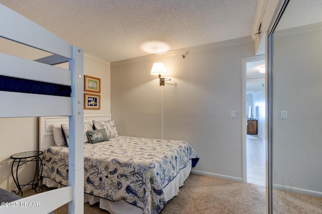 bedroom featuring ornamental molding, carpet, and a textured ceiling