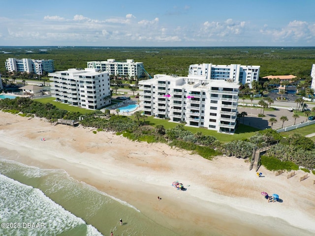 aerial view with a water view and a beach view