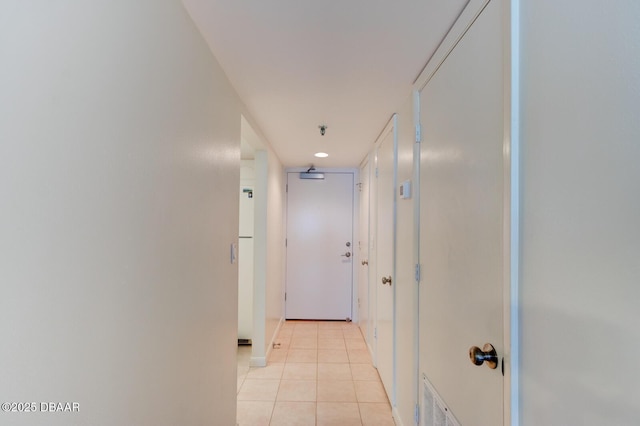 hall featuring light tile patterned floors