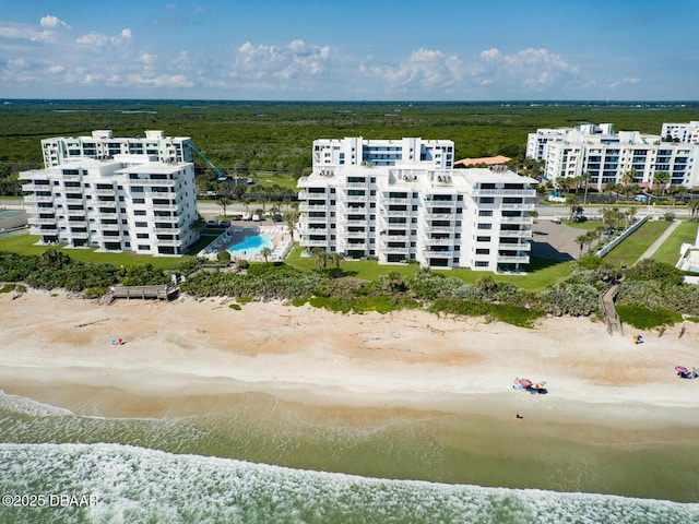 birds eye view of property with a water view and a view of the beach