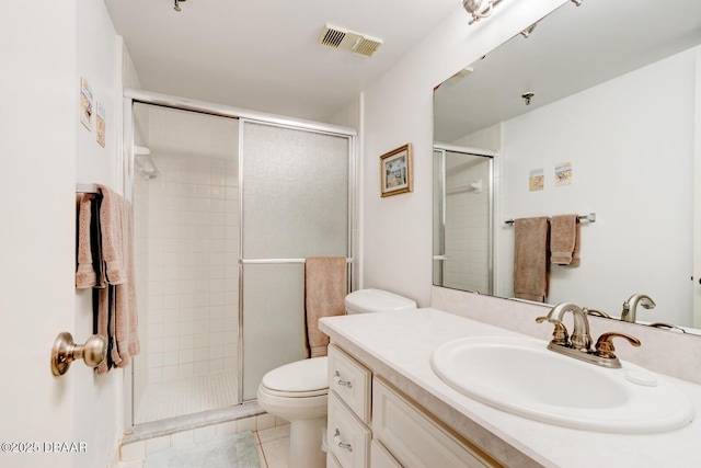 bathroom featuring an enclosed shower, vanity, tile patterned flooring, and toilet