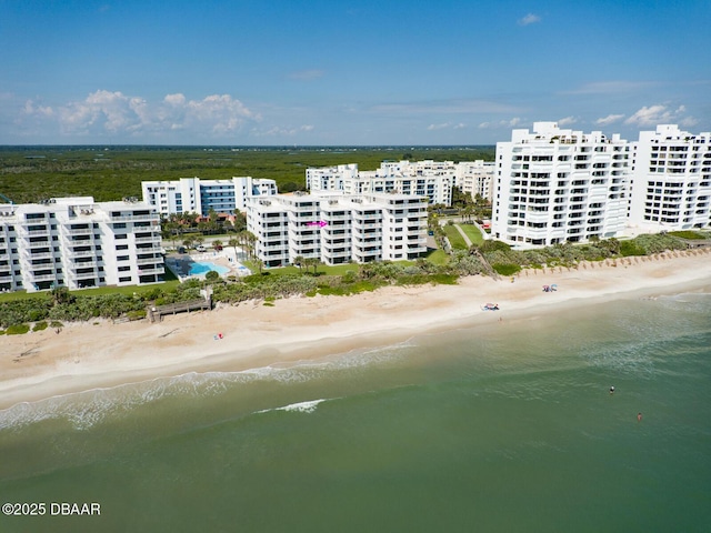 birds eye view of property featuring a water view and a beach view