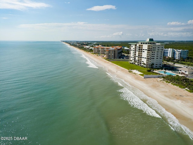 drone / aerial view featuring a water view and a beach view