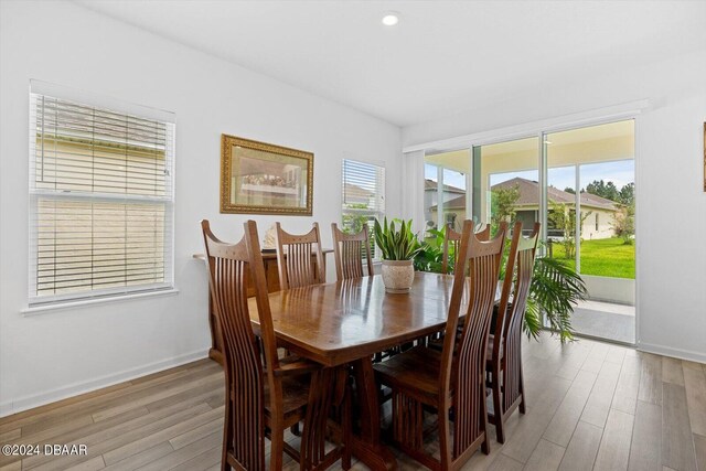 dining space with plenty of natural light and light hardwood / wood-style flooring