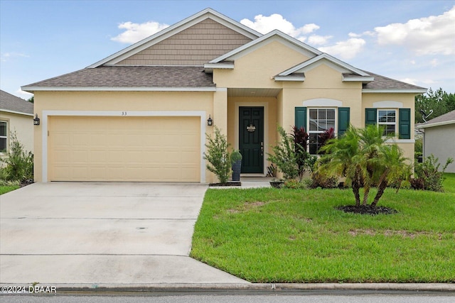 view of front of property with a garage and a front yard