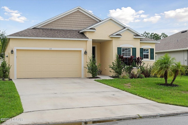 view of front of house with a garage and a front yard