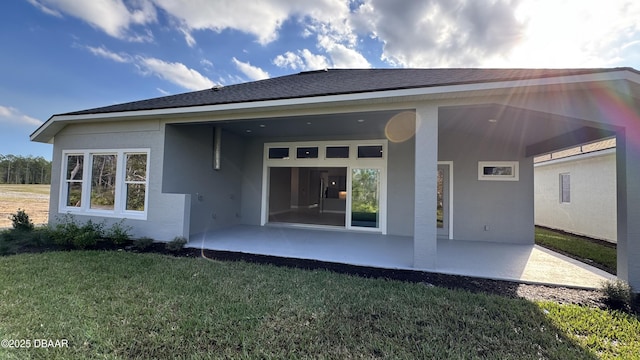 back of house with a lawn and a patio area