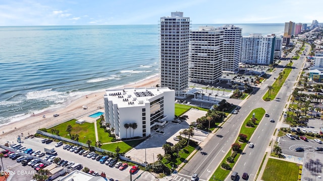 birds eye view of property with a beach view and a water view