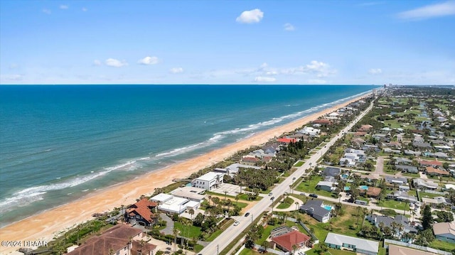 drone / aerial view featuring a view of the beach and a water view