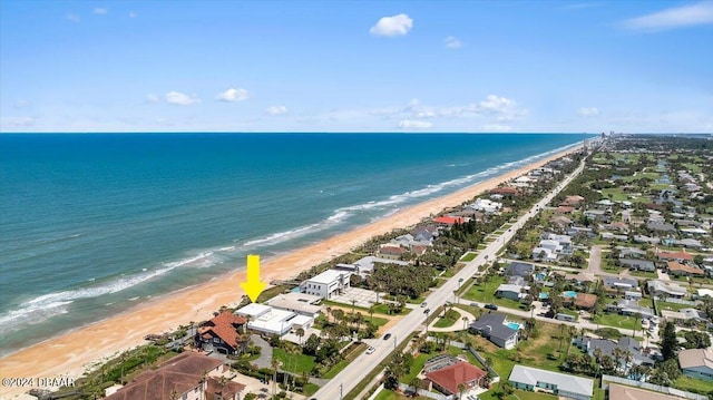 birds eye view of property featuring a view of the beach and a water view