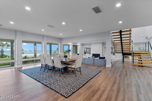 dining space featuring hardwood / wood-style flooring and a fireplace