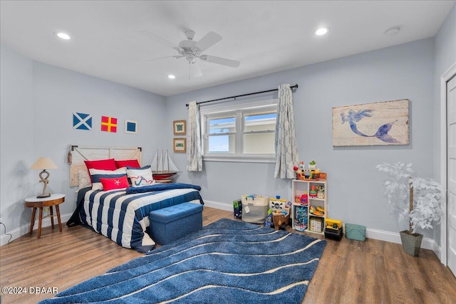 bedroom with ceiling fan and dark hardwood / wood-style flooring