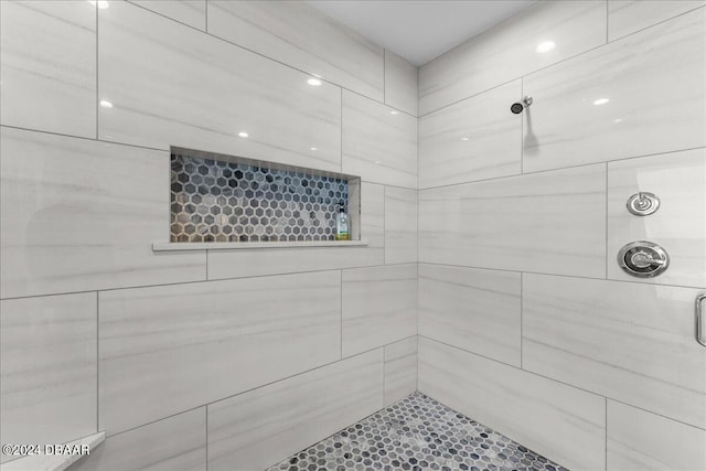 bathroom with a shower with door