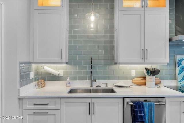 kitchen featuring tasteful backsplash, sink, and white cabinets